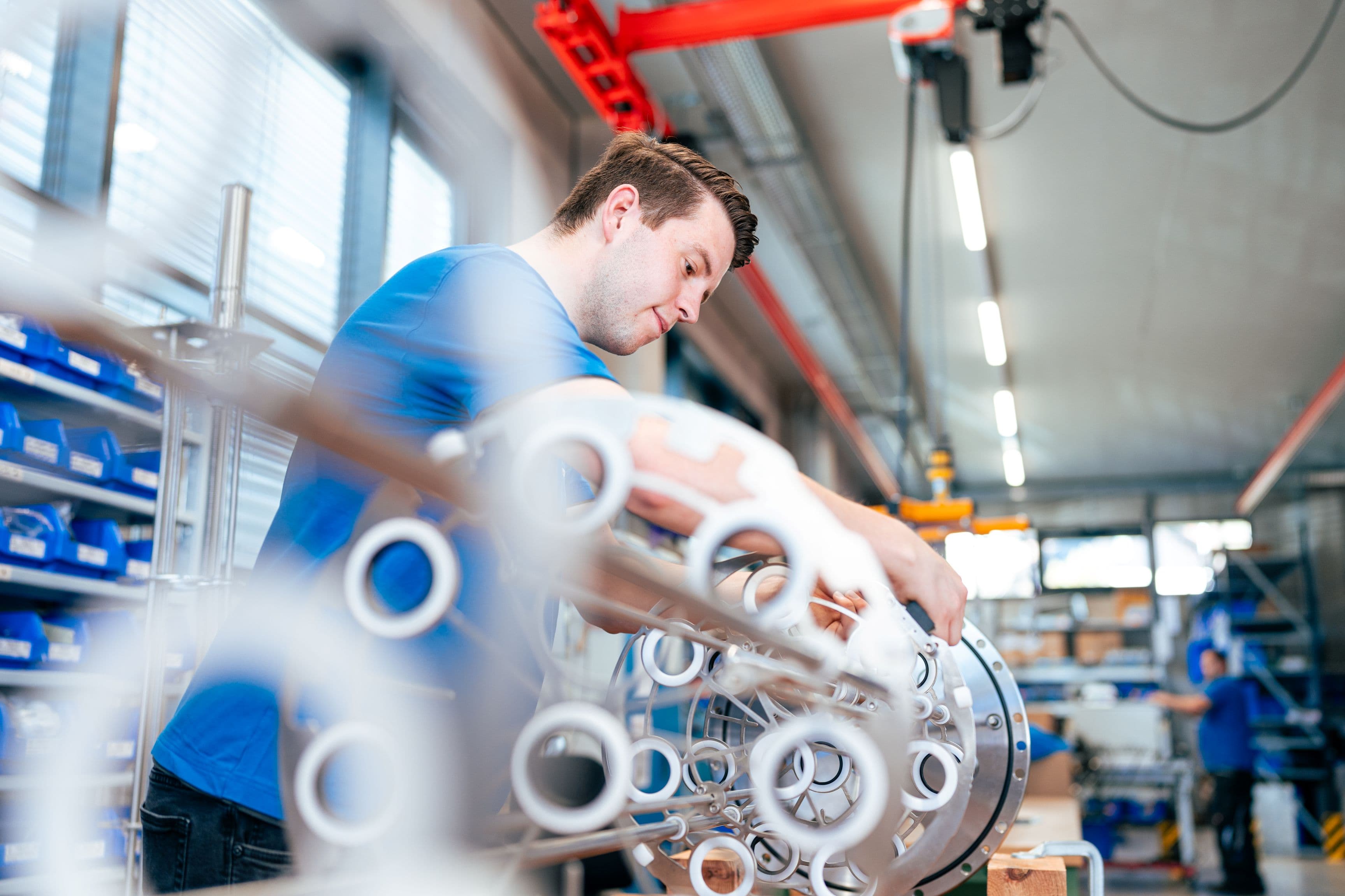 an AQUAFIDES employee assembling a UV system